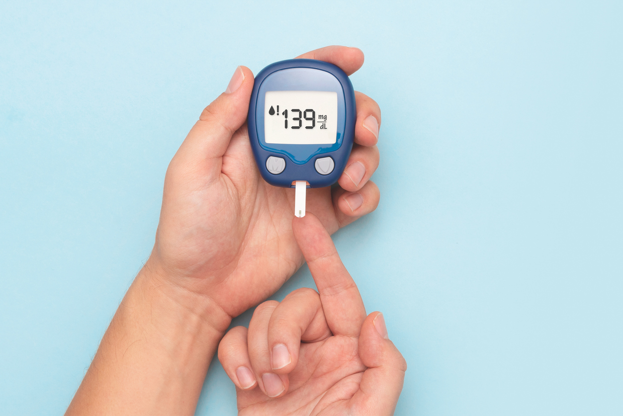 Man using glucometer, blood glucose test. Diabetes concept